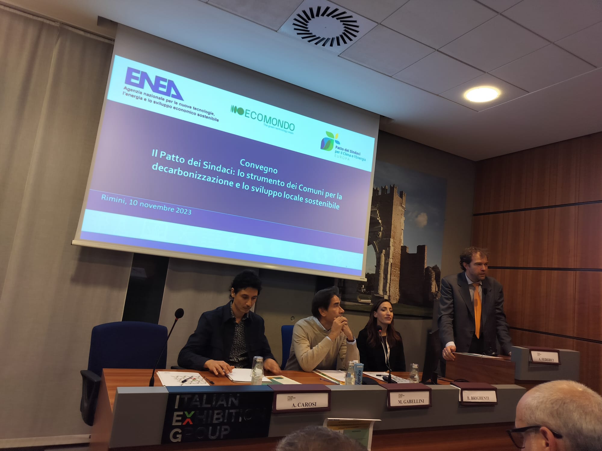 L'intervento introduttivo di Alessandro Federici (in piedi a sinistra) nell'ambito della la conferenza Il Patto dei Sindaci: lo strumento dei Comuni per la decarbonizzazione e lo sviluppo locale sostenibile 
